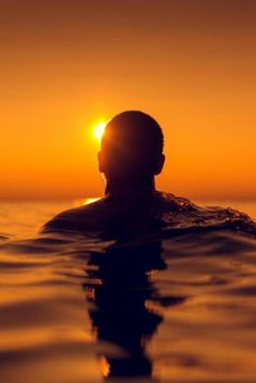 a man swimming in the ocean at sunset with a quote above him that reads, who will be your hitch?