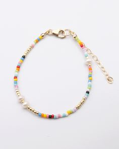 With the multicolor beads of the Marthe Bracelet pairing with so many outfit colors, you may just find yourself wearing this for most of the spring and summer! We especially love the special freshwater pearls mixed in with the seed beads here and there for a little something extra. Love this look? Add the Marthe Necklace for a complete look. About the Artisan Marie Marthe is a wonderful Haitian artisan that has been a part of our team for years! She is a talented seamstress and dedicated team me Elegant Beads Bracelet, Spring Gold Beaded Bracelets With Colorful Beads, Multicolor Pearl Bracelets With Round Beads, Multicolor Beaded Bracelets For Spring, Spring Multicolor Beaded Bracelets With Round Beads, Multicolor Pearl Bracelet With Spacer Beads, Adjustable Multicolor Pearl Bracelet With Colorful Beads, Handmade Multicolor Pearl Beaded Bracelets, Multicolor Pearl Charm Bracelets With Round Beads