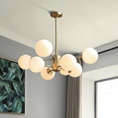 This product is a chandelier made of metal with a frosted white glass ball. It has a minimalist gold finish and hangs from the ceiling. It is perfect for a dining room. It comes in different sizes with various fixture widths, heights, and chain/cord lengths. The bulb is not included.Size: 25 Inch & Above Fixture Width: 27.5" 31.5" 40" Fixture Height: 17” 20" Bulb Included: No Number of Lights: 6 8 12 Color: Gold Style: Modern Material: Metal Fixture Type: Chandelier Feature: Frosted Glass shades Chandelier Minimalist, Glass Ball Chandelier, Ball Chandelier, Tiger Decor, Light For Dining Room, Etsy Decor, Hanging Ceiling, Hanging Ceiling Lights, Shared Rooms