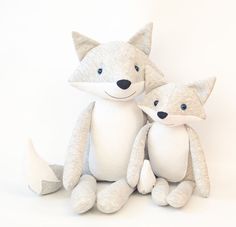 two stuffed foxes sitting next to each other