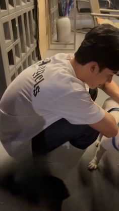 a man washing a dog in a sink