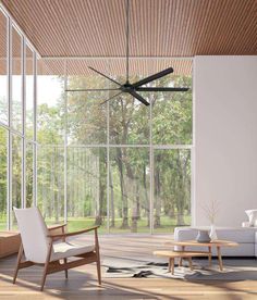 a modern living room with large windows and a ceiling fan that is mounted on the wall