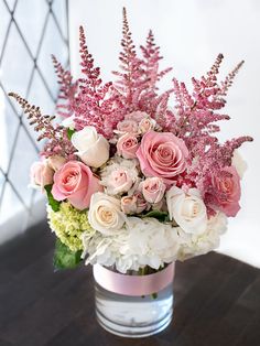 a vase filled with pink and white flowers