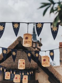 some paper lanterns hanging from a line outside