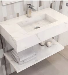 a white sink sitting under a mirror in a bathroom