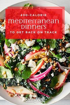 a white plate topped with salad covered in spinach and radishes next to a fork