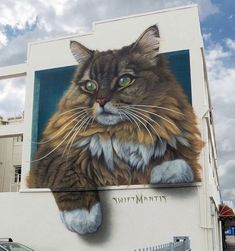 a large cat painted on the side of a building