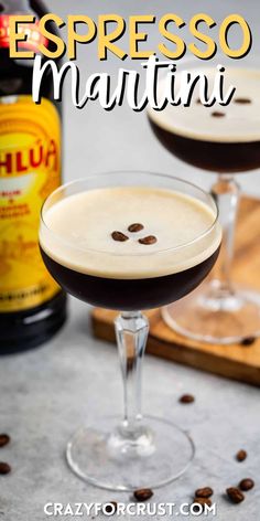 two glasses filled with espresso martini on top of a table