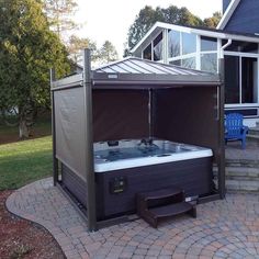 a hot tub sitting on top of a brick patio