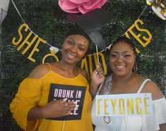 two women standing next to each other in front of a sign that says drunk in feyronce