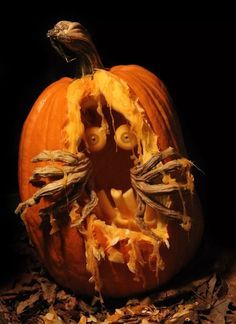 a carved pumpkin sitting on top of leaves