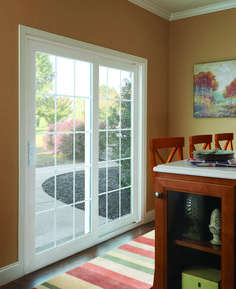 a dining room with sliding glass doors leading to an outside patio and picnic table area