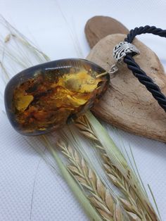 Welcome to my handmade shop. Item description: Dark green unisex Amber pendant with some light yellow parts. Rough Amber. Healthy stone. Long black cord (about 60 cm) Weight: 27.80 gr Lenght:7-3.5 cm (2.75-1.37 inches) This item was made of natural Baltic Amber. All the amber used in my jewelry is collected in my home country Lithuania. I sell only genuine, authentic, real, natural Baltic Amber. Item may have natural imperfections. Due to amber being natural, each of my jewelry is unique and eve Gift Necklaces With Baltic Amber And Natural Stones, Baltic Amber Necklace With Natural Stones For Gift, Gift Necklace With Baltic Amber And Natural Stones, Earthy Necklace With Large Stone For Gifts, Brown Baltic Amber Jewelry For Gift, Amber Necklace With Large Stone For Gift, Amber Necklace With Large Stone As Gift, Handmade Baltic Amber Necklace In Spiritual Style, Gift Natural Stones Baltic Amber Necklaces