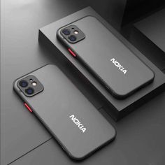 two iphone cases sitting on top of a table next to each other with the word nokia printed on them