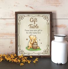 there is a sign that says cards and gifts next to a vase with yellow flowers