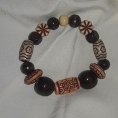 Handmade wooden bracelet it was created by my mother.  For men or women.  Stretchy Boho style Brown Wooden Bracelets With Round Beads, Unique Handmade Brown Beaded Bracelets, Brown Wood Beaded Bracelets, Traditional Wooden Bracelets With Round Beads, Bohemian Wood Bracelet Jewelry, Traditional Wood Bracelets With Round Beads, Brown Wooden Beaded Bracelets As A Gift, Brown Wooden Beaded Bracelet As A Gift, Traditional Wooden Bracelet With Round Beads