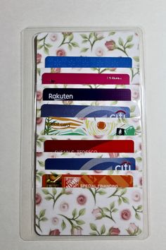 the card holder is decorated with colorful flowers and ribbons on it's front side