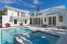 a large white house with a swimming pool