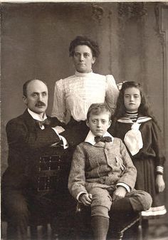 an old black and white photo of a family posing for a photograph in the early 1900's