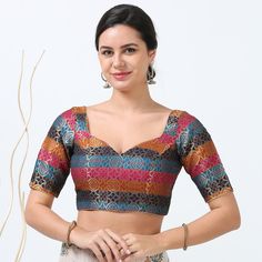 Elevate your traditional wardrobe with our multi-color silk readymade blouse, designed to blend seamlessly with a variety of sarees. Crafted from luxurious silk, this blouse features a vibrant array of colors and intricate patterns that add a touch of elegance to any ensemble. The high-quality fabric ensures comfort and durability, while the expert tailoring offers a flattering fit for a range of body types. Ideal for festive occasions or special events, this blouse is a versatile addition that enhances both the beauty of your saree and your overall style. Please be aware that color variation may occur due to lighting and screen effects. Fabric :Silk Blend  Lining :Yes Padding :Yes Size: 34 to 40 Sleeve Length: Above Elbow Front Neck: Sweet Heart Closure: Back Special Feature :Beautiful Mu Traditional Wardrobe, Blouse Designed, Latest Model Blouse Designs, Heart Blouse, Of Sarees, Readymade Saree, Organza Sarees, Blouse Models, Blouse Neck Designs