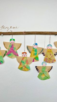 paper angel ornaments hanging on a wall