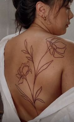 a woman with a flower tattoo on her back