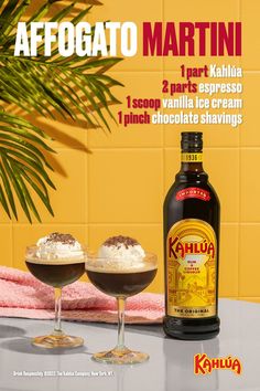 two glasses filled with ice cream next to a bottle of kahlua chocolate syrup