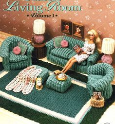 a crocheted living room set with a doll sitting on the couch in front of it