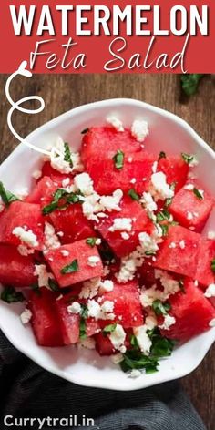 watermelon feta salad in a white bowl on top of a wooden table