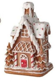 a gingerbread house ornament on a white background