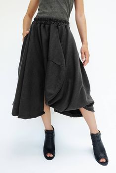 "🚚..ALL ORDERS ARE SHIPPED VIA DHL EXPRESS MAIL Treating every design as a piece of art, look no further than asymmetric midi skirt/pants. This special design skirt has one leg of pants. Asymmetric panelled construction. Wide elastic waistband. Tonal stitching. Asymmetric hem. * Pull-on style * 2\" elastic waistband * The skirt has one left leg of pants * Tonal stitching * Side seam pockets * Asymmetric hem * Unlined Measurements approximately: Waist: 26\" stretching to 46\" (66 cm-117 cm)-elas Chic Asymmetrical Cotton Bottoms, Asymmetrical Cotton Bottoms For Fall, Fall Skirt With Pockets And Asymmetrical Hem, Asymmetrical Baggy Bottoms For Spring, Baggy Asymmetrical Bottoms For Spring, Baggy Pleated Skirt For Fall, Spring Baggy Asymmetrical Bottoms, Baggy Skirt For Fall, Baggy Fall Skirt