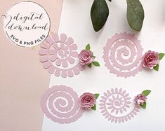 some pink flowers and green leaves on a white paper with a tag that says digital design studio