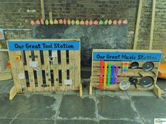 two wooden crates with magnets on them sitting next to each other in front of a brick wall