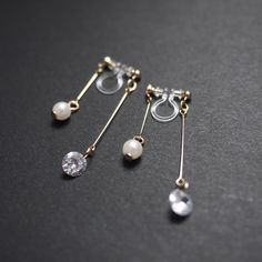 Double sided cz crystal clip on earrings, cubic zirconia, silver clip on earrings dangle, invisible clip on earrings, pearl clip on earrings 💖More pierced look and comfortable invisible clip on earrings are available at MiyabiGrace home page. Please click the link below https://www.etsy.com/shop/MiyabiGrace Details ◆Length:1.57 inches (4 cm) ◆Weight:1 g (0.04 oz) ◆Color: Gold ✨These are gorgeous double sided invisible clip on earrings. Pearls are attached to the front and cubic zirconia crystal Clip On Earrings Dangle, Dangly Clip On Earrings, Diy Clip On Earrings, Prom Inspo, Gold Clips, Handmade Wire Jewelry, Earrings Pearl, Handmade Wire, Delicate Earrings