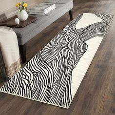 a zebra print rug on the floor in a living room with a bench and coffee table