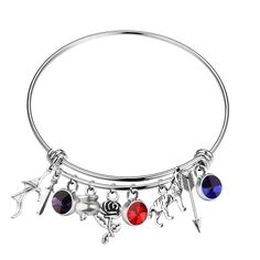 a silver bang bracelet with charms on the bottom and an arrow charm in the middle