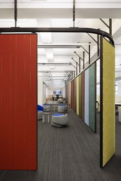 an office with colorful partitions and chairs in the center, along with other furniture