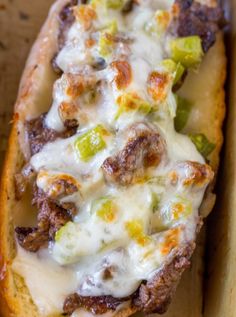 an open faced philly cheese steak sandwich in a box with the title above it