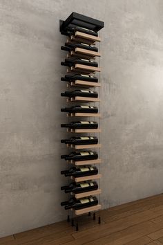 a tall wooden wine rack sitting on top of a hard wood floor next to a wall