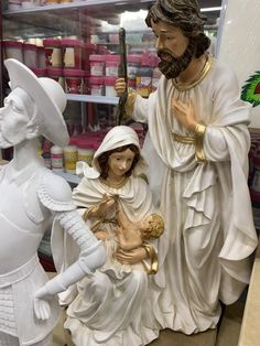 statues of jesus, mary and baby jesus in a store