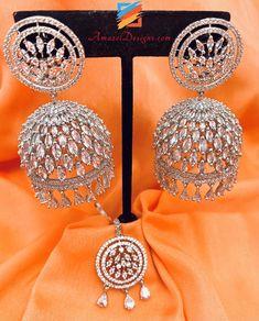 American Diamond (AD) Silver Jhumka Earrings Tikka Set. Available to shop online and delivered to your doorsteps anywhere in the world with our Everything-Everywhere FREE Shipping. 📦Unmatched FREE Worldwide Shipping EXPLORE more Maang Tikka Sets and Tikka Set Punjabi AMERICAN DIAMOND JEWELLERY Match with our pretty Single Line Necklaces Alisha, Canada ⭐️⭐️⭐️⭐️⭐️ 🙋🏻‍♀️I had a wonderful experience with 🌸Amazel Designs🌸.The way Kiran follow you through the shipment was great. Great service and Luxury Bollywood American Diamond Jhumkas, Ad Jhumka Earrings, Luxury Fusion Style American Diamond Jhumkas, Silver Jhumka Earrings, Maang Tikka Set, American Diamond Jewellery, Maang Tikka, Jhumka Earrings, Modest Fashion Outfits