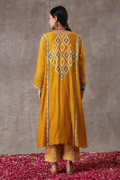 Yellow long kurta with geometric hand block prints and embroidered highlights. Paired with printed pant.
Component: 2
Pattern: Printed
Type Of Work: Hand Block Print
Neckline: Round
Sleeve Type: Full
Fabric: Chanderi, Cotton Flax
Color: Yellow
Other Details: 
Front button placket
Occasion: Mehendi and Haldi - Aza Fashions Yellow Chanderi Sets With Motifs, Bohemian Mulmul Sharara With Block Print, Navratri Chanderi Block Print Sharara, Transitional Chanderi Kurta With Block Print, Designer Chanderi Salwar Kameez With Block Print, Festival Chanderi Palazzo Set With Block Print, Traditional Palazzo Set With Block Print, Bohemian Embroidered Cotton Silk Sets, Yellow Block Print Straight Kurta