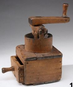 an old wooden grinder sitting on top of a table