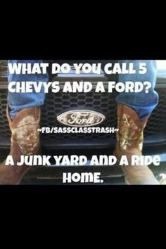 a man in cowboy boots standing on the hood of a car