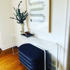 there is a plant in a vase on top of a chair next to the radiator