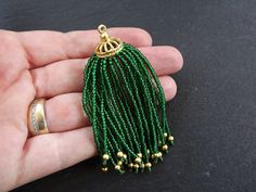 Stunning emerald green seed bead tassel with spoke detail cap. More tassels available here: https://www.etsy.com/shop/LylaSupplies/search?search_query=tassel&order=date_desc&view_type=gallery&ref=shop_search Quantity: 1 pc Shape: Seed bead Tassel Size: approx. 72 x 20 mm Color: Emerald Green & Gold plated brass Please note that colors may vary slightly from the photo. This is due to different color/brightness settings of computer/laptop screens All my findings are lead free, nick Traditional Green Jewelry With Bead Caps, Green Beads With Bead Caps For Jewelry Making, Laptop Screens, Gold Bee, Evil Eye Charm, Beaded Fringe, Computer Laptop, Beaded Tassels, Matte Gold