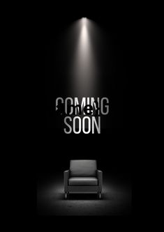 a black and white photo with the words coming soon in front of a couch under a spotlight