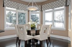 a dining room table with four chairs around it