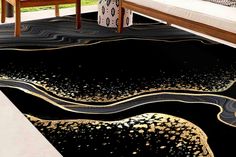 a living room with black and gold rugs on the floor