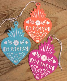 three heart shaped ornaments with the words happy birthday written on each ornament, hanging from string